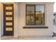 Exterior view showcasing the front door and window with black trim at 2656 E Oriole Dr, Gilbert, AZ 85297