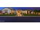 Charming home featuring manicured lawn, stone walkway and warm exterior lighting at 2656 E Oriole Dr, Gilbert, AZ 85297