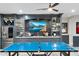 Spacious game room features a bar area with stainless steel refrigerator and granite countertops at 2656 E Oriole Dr, Gilbert, AZ 85297
