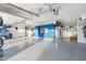 Bright, spacious garage with epoxy floors, slat wall organization system, and custom storage cabinets at 2656 E Oriole Dr, Gilbert, AZ 85297