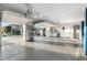 Garage features epoxy floor, overhead racks, and access to outdoor area with mature trees at 2656 E Oriole Dr, Gilbert, AZ 85297