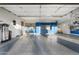 Spacious garage with epoxy flooring, ample storage, overhead racks, and slat wall organizational system at 2656 E Oriole Dr, Gilbert, AZ 85297