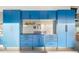 Garage features custom blue cabinets, slat wall system, and workbench for organized storage at 2656 E Oriole Dr, Gilbert, AZ 85297