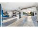 Garage with epoxy floor, organization system, and open doors to a landscaped yard at 2656 E Oriole Dr, Gilbert, AZ 85297