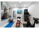 Home gym equipped with a stationary bike, weights, a TV and a mirror at 2656 E Oriole Dr, Gilbert, AZ 85297