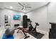 Spacious home gym featuring workout equipment and a wall-mounted television at 2656 E Oriole Dr, Gilbert, AZ 85297
