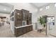 Elegant hallway featuring built-in display cabinet with glass doors and stylish decor at 2656 E Oriole Dr, Gilbert, AZ 85297