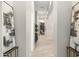 Bright, open hallway with light wood floors and stylish decor, creating an inviting path through the home at 2656 E Oriole Dr, Gilbert, AZ 85297