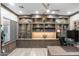 Well-appointed home office with custom built-ins and wood floors for a professional workspace at 2656 E Oriole Dr, Gilbert, AZ 85297