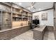 Stylish home office featuring custom shelving and a spacious desk for productivity and organization at 2656 E Oriole Dr, Gilbert, AZ 85297