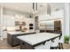 Elegant kitchen with white cabinets, stainless steel appliances, and a large island with seating at 2656 E Oriole Dr, Gilbert, AZ 85297