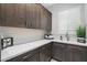 Laundry room with gray cabinets, quartz countertops, and a sink at 2656 E Oriole Dr, Gilbert, AZ 85297