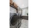 Well-equipped laundry room features modern appliances and stylish patterned flooring at 2656 E Oriole Dr, Gilbert, AZ 85297