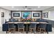 Basement entertainment center and table area with a large comfortable sectional sofa and a wooden table at 2656 E Oriole Dr, Gilbert, AZ 85297
