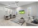Open concept living area with modern furniture, and plantation shutters at 2656 E Oriole Dr, Gilbert, AZ 85297