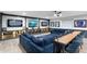 Basement entertainment center and table area with a large comfortable sectional sofa and a wooden table at 2656 E Oriole Dr, Gilbert, AZ 85297