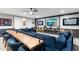 Basement entertainment center and table area with a large comfortable sectional sofa and a wooden table at 2656 E Oriole Dr, Gilbert, AZ 85297