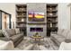Comfortable living room featuring built-in shelving, fireplace, and cozy seating arrangement at 2656 E Oriole Dr, Gilbert, AZ 85297