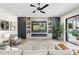 Stylish living room featuring a modern entertainment center, fireplace, and comfortable seating at 2656 E Oriole Dr, Gilbert, AZ 85297