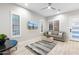 Bright living room with wood look tile, plantation shutters, and stylish furnishings at 2656 E Oriole Dr, Gilbert, AZ 85297