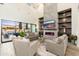 Modern living room with high ceilings, fireplace, open floor plan and expansive windows at 2656 E Oriole Dr, Gilbert, AZ 85297