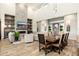 Open-concept living space with fireplace, dining area and view to the outdoor space at 2656 E Oriole Dr, Gilbert, AZ 85297