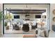Expansive covered patio with built-in kitchen, seating, and multiple TVs, perfect for entertaining at 2656 E Oriole Dr, Gilbert, AZ 85297