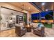 Inviting covered patio features a fireplace, comfortable seating, and seamless indoor-outdoor living with a sliding glass door at 2656 E Oriole Dr, Gilbert, AZ 85297