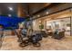 Covered patio with an outdoor kitchen, dining area, and a glimpse of the inviting pool perfect for outdoor gatherings at 2656 E Oriole Dr, Gilbert, AZ 85297