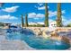 Beautiful backyard pool with a built-in slide, water features, and comfortable lounging areas at 2656 E Oriole Dr, Gilbert, AZ 85297
