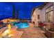 Beautiful pool area with a bar, waterfall, and fire feature, perfect for outdoor entertaining at 2656 E Oriole Dr, Gilbert, AZ 85297