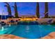 Beautiful pool with water features, a water slide, and outdoor lounge chairs at 2656 E Oriole Dr, Gilbert, AZ 85297