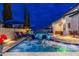 Inviting pool and hot tub with fire features, a waterfall, and an outdoor kitchen at 2656 E Oriole Dr, Gilbert, AZ 85297