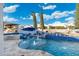 Stunning backyard pool with a rock waterfall, poolside lounging, and manicured trees at 2656 E Oriole Dr, Gilbert, AZ 85297