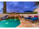 Beautiful pool area with a rock waterfall and slide, perfect for relaxing and enjoying the outdoors at 2656 E Oriole Dr, Gilbert, AZ 85297