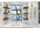 Stylish wet bar with quartz countertops, wine racks, and view of the backyard pool at 2656 E Oriole Dr, Gilbert, AZ 85297