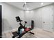 Bright workout room features modern exercise equipment on wood-look floors, perfect for home fitness at 2656 E Oriole Dr, Gilbert, AZ 85297