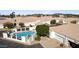 An aerial view of home with a fenced pool, desert landscaping, driveway, and a two-car garage at 320 S 70Th St # 54, Mesa, AZ 85208