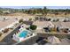 Elevated view of a residential property with a pool, desert landscaping, driveway, and garage at 320 S 70Th St # 54, Mesa, AZ 85208
