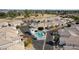 Aerial view of a community featuring a shared pool with spa, desert landscaping, and easy access to nearby park and recreation at 320 S 70Th St # 54, Mesa, AZ 85208