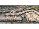 Aerial view of a residential community with desert landscaping, pools, and red tiled roofs at 320 S 70Th St # 54, Mesa, AZ 85208