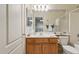 Bathroom with a white countertop and sink, wooden cabinets, and a large mirror at 320 S 70Th St # 54, Mesa, AZ 85208