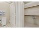 Bright bathroom featuring a walk-in closet, tiled floors, and white cabinets at 320 S 70Th St # 54, Mesa, AZ 85208