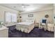 Brightly lit bedroom features a ceiling fan, plush carpeting, and charming decor at 320 S 70Th St # 54, Mesa, AZ 85208