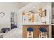 Kitchen breakfast bar with seating and tile floors, open to other rooms at 320 S 70Th St # 54, Mesa, AZ 85208