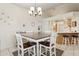 Open-concept dining area adjacent to the kitchen with modern lighting at 320 S 70Th St # 54, Mesa, AZ 85208
