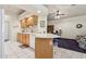 Well-lit kitchen features a breakfast bar, tiled floors, and view of the living area with ceiling fan at 320 S 70Th St # 54, Mesa, AZ 85208