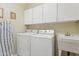 Laundry room featuring a washer, dryer, wash basin, and plenty of storage at 320 S 70Th St # 54, Mesa, AZ 85208
