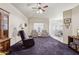 Spacious carpeted living room featuring a ceiling fan, large windows, and classic furnishings at 320 S 70Th St # 54, Mesa, AZ 85208