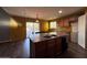 Kitchen featuring island with sink, dishwasher, and dining table, sliding glass doors and backyard access at 3229 S 93Rd Ave, Tolleson, AZ 85353